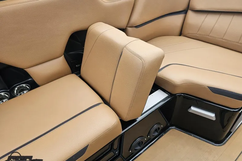 Slide: The Image of 2022 Supra SE 550 interior with tan leather seating and cup holders. - 61