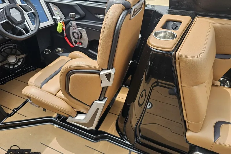 Slide: The Image of Interior of a 2022 Supra SE 550 boat with tan leather seats and modern dashboard. - 66