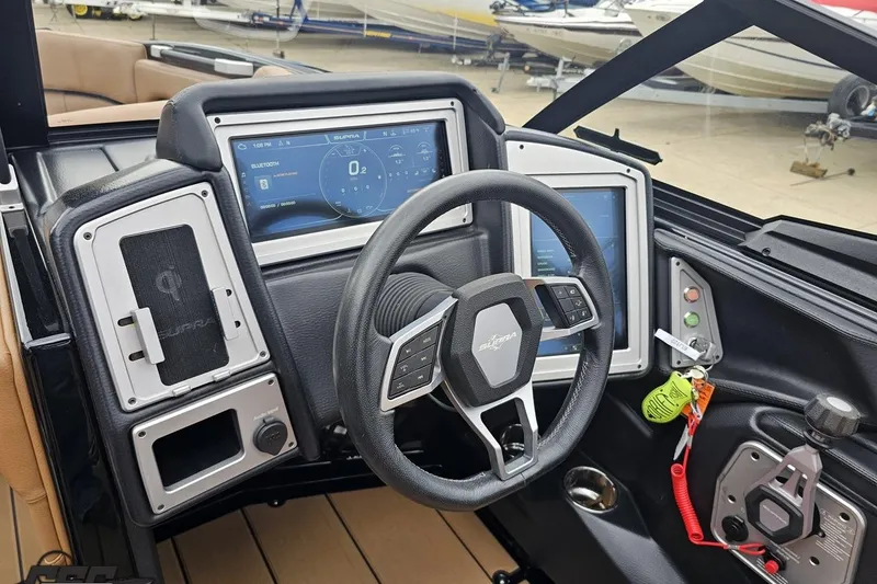 Slide: The Image of 2022 Supra SE 550 boat dashboard with advanced digital controls and steering wheel. - 68