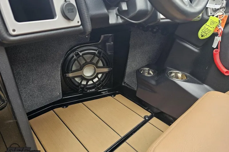 Slide: The Image of 2022 Supra SE 550 interior with JL Audio speaker and dual cup holders. - 69
