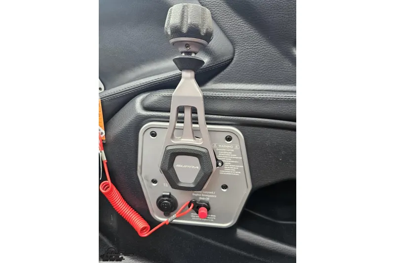 Slide: The Image of Control panel of a 2022 Supra SE 550 boat with red coiled safety cord. - 76