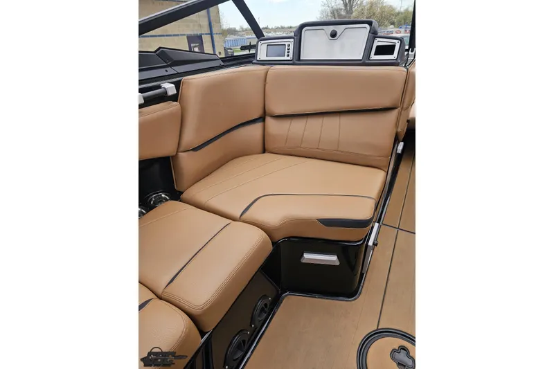 Slide: The Image of 2022 Supra SE 550 boat interior with tan leather seating and sleek design. - 78
