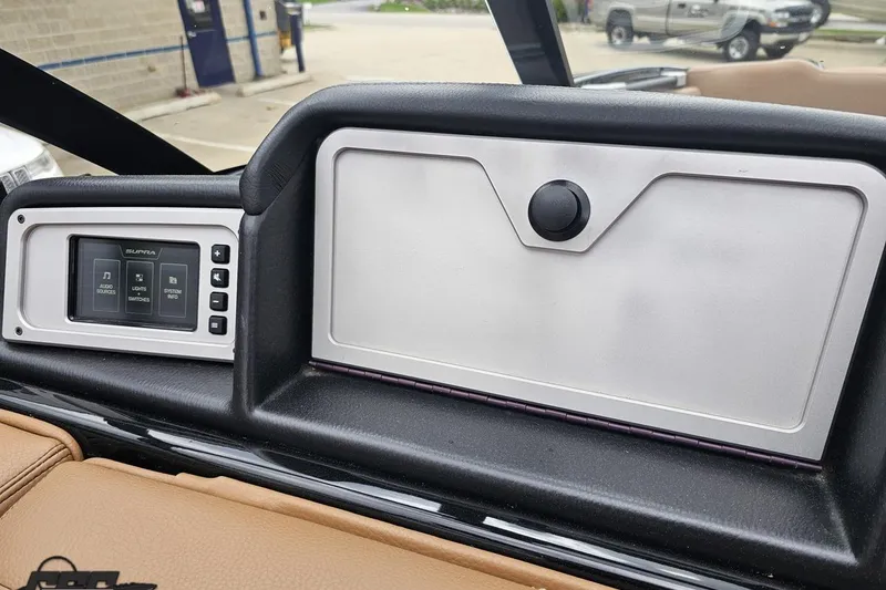 Slide: The Image of 2022 Supra SE 550 dashboard featuring a sleek control panel and storage compartment. - 80