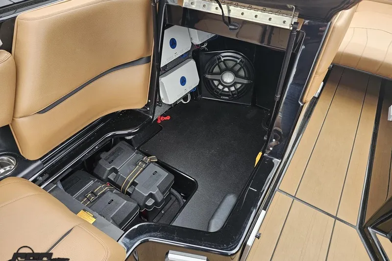 Slide: The Image of 2022 Supra SE 550 boat interior with storage compartments and audio system. - 84