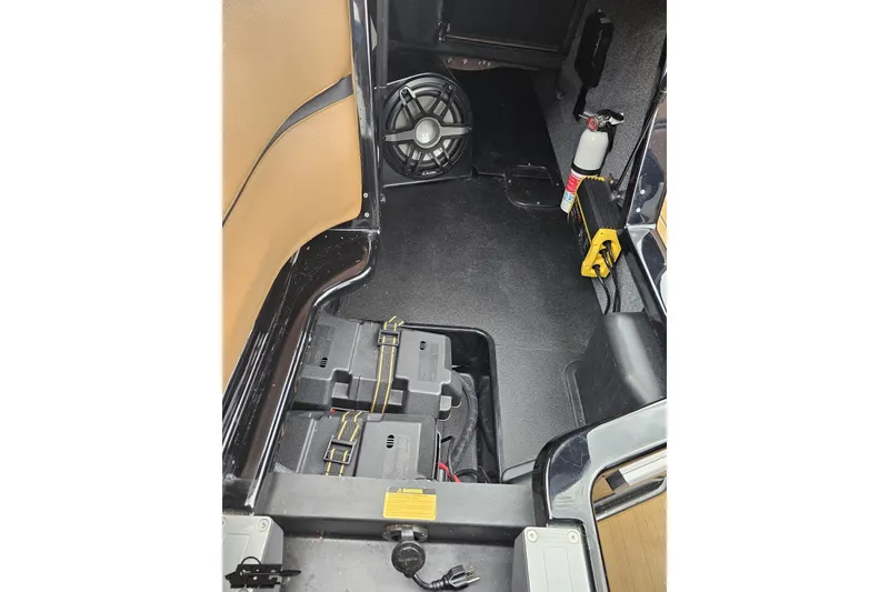 Slide: The Image of 2022 Supra SE 550 interior showing speaker, battery compartment, and fire extinguisher. - 85