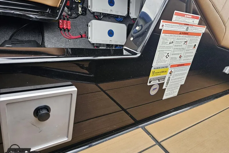 Slide: The Image of Interior view of a 2022 Supra SE 550 boat showing electrical components and safety warnings. - 87