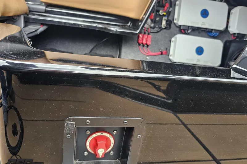 Slide: The Image of 2022 Supra SE 550 boat interior with electrical components and red power switch. - 88