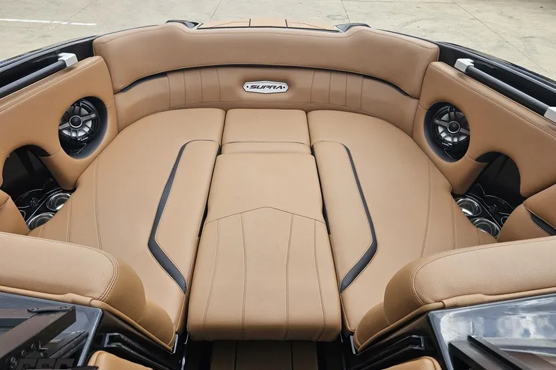 Slide: The Image of Luxurious interior of 2022 Supra SE 550 boat with tan leather seating and built-in speakers. - 90