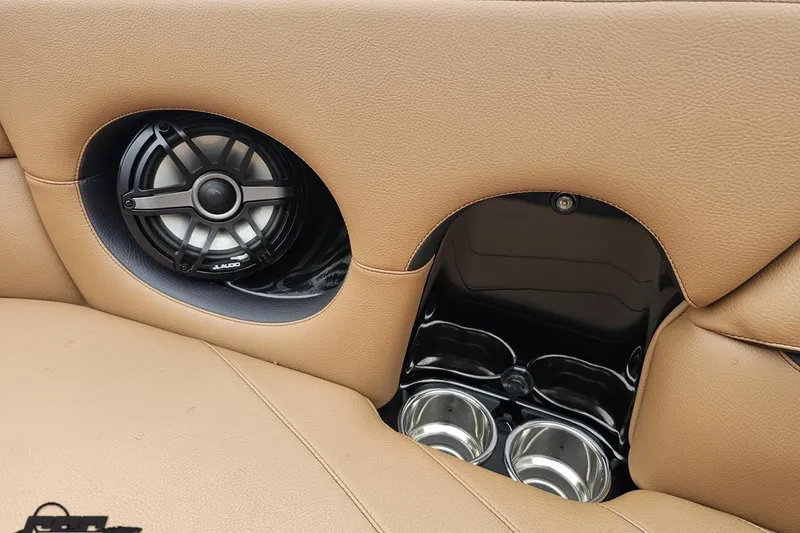 Slide: The Image of 2022 Supra SE 550 interior with speaker and cup holders in tan leather. - 94