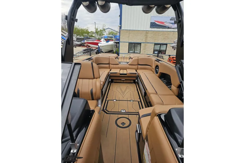 Slide: The Image of 2022 Supra SE 550 boat interior with tan leather seating and sleek design. - 97