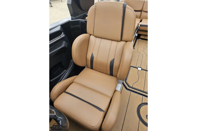 Slide: The Image of Luxurious tan leather seat in 2022 Supra SE 550 boat interior. - 99