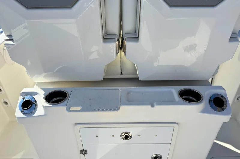 Slide: The Image of 2021 Pursuit S 268 Sport boat console with cup holders and storage compartment. - 10