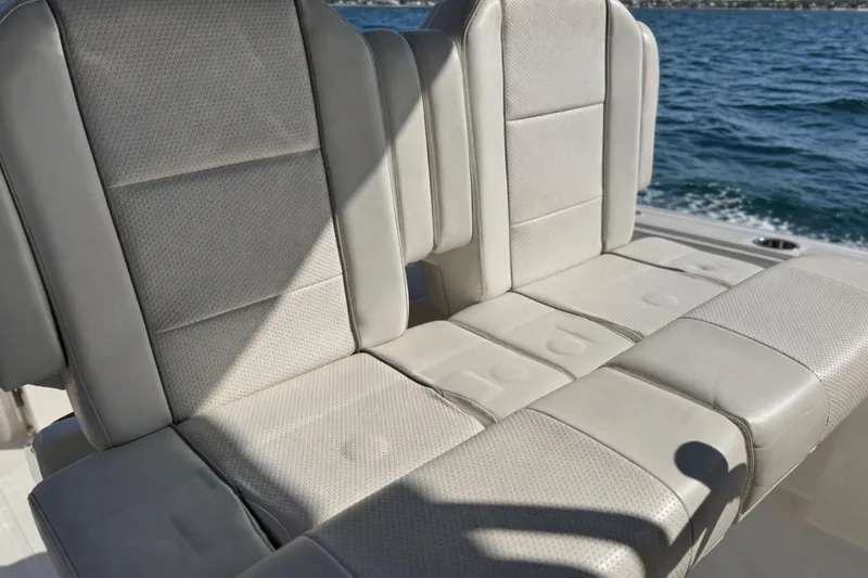 Slide: The Image of 2021 Pursuit S 268 Sport boat seats with ocean backdrop. - 12