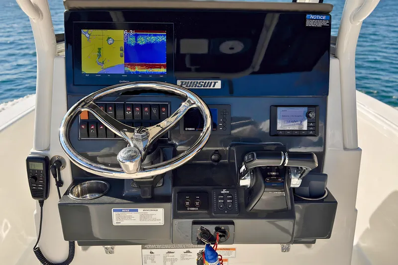 Slide: The Image of Dashboard of 2021 Pursuit S 268 Sport boat with navigation and control systems. - 13