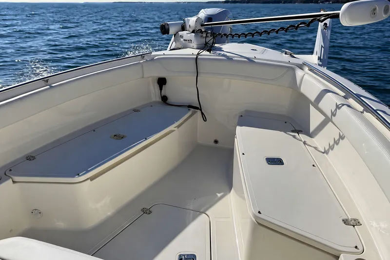 Slide: The Image of 2021 Pursuit S 268 Sport boat interior with seating and storage on open water. - 14