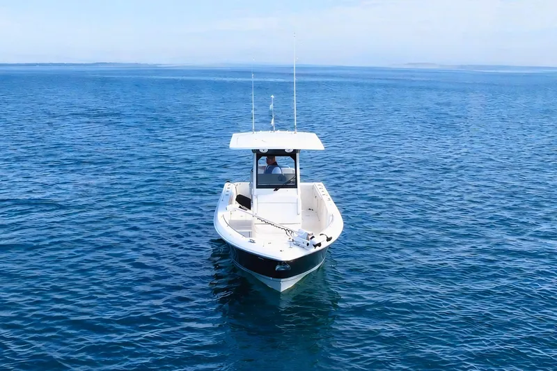 Slide: The Image of 2021 Pursuit S 268 Sport boat on calm blue ocean waters. - 6