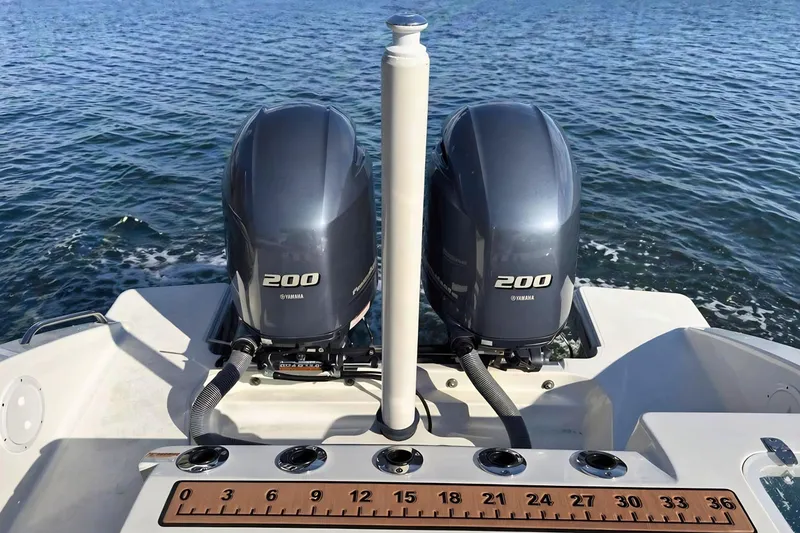 Slide: The Image of Twin Yamaha 200 engines on a 2021 Pursuit S 268 Sport boat, ocean backdrop. - 9