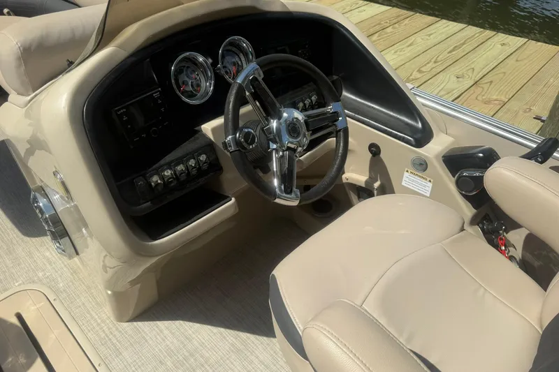 Slide: The Image of 2018 Avalon Catalina Funship Platinum boat dashboard with steering wheel and controls. - 15