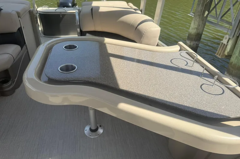 Slide: The Image of 2018 Avalon Catalina Funship Platinum boat interior with table and cup holders. - 17