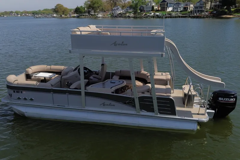 Slide: The Image of 2018 Avalon Catalina Funship Platinum pontoon boat with slide on a lake. - 2