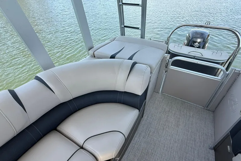 Slide: The Image of 2018 Avalon Catalina Funship Platinum boat interior with plush seating and water view. - 21