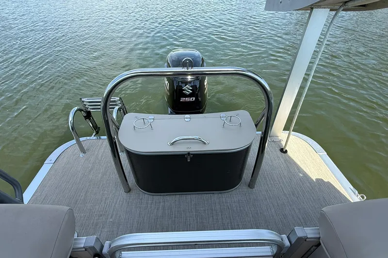 Slide: The Image of 2018 Avalon Catalina Funship Platinum boat deck with Suzuki 250 motor on water. - 22