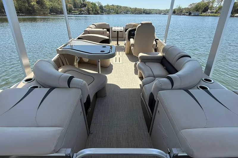 Slide: The Image of 2018 Avalon Catalina Funship Platinum pontoon boat interior with luxurious seating on a serene lake. - 23