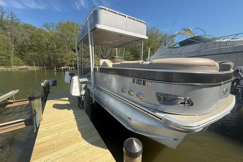 Slide: The Image of 2018 Avalon Catalina Funship Platinum pontoon boat docked on a sunny day. - 37