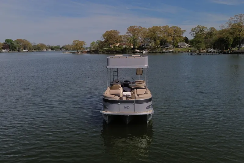 Slide: The Image of 2018 Avalon Catalina Funship Platinum pontoon boat on a serene lake. - 7