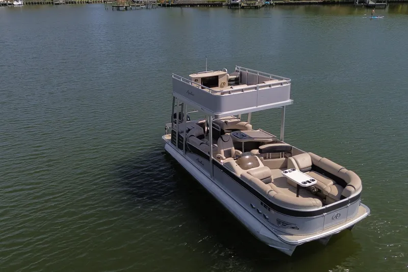 Slide: The Image of 2018 Avalon Catalina Funship Platinum pontoon boat on calm water, featuring spacious seating and upper deck. - 9