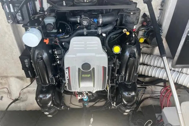 Slide: The Image of Engine compartment of a 2015 Rinker 276 Captiva Cuddy boat, showcasing detailed components. - 19