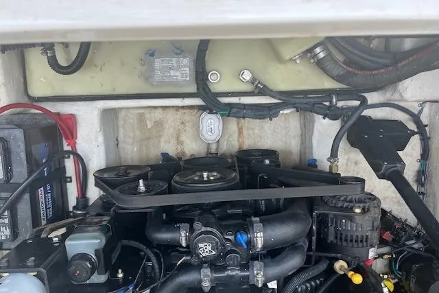 Slide: The Image of Engine compartment of a 2015 Rinker 276 Captiva Cuddy boat, showcasing mechanical components. - 20