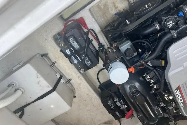 Slide: The Image of Engine compartment of a 2015 Rinker 276 Captiva Cuddy with visible battery and components. - 21