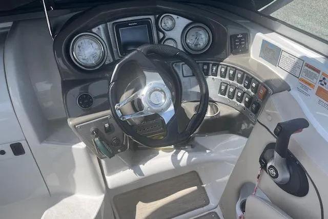 Slide: The Image of 2015 Rinker 276 Captiva Cuddy dashboard with steering wheel and control panel. - 5