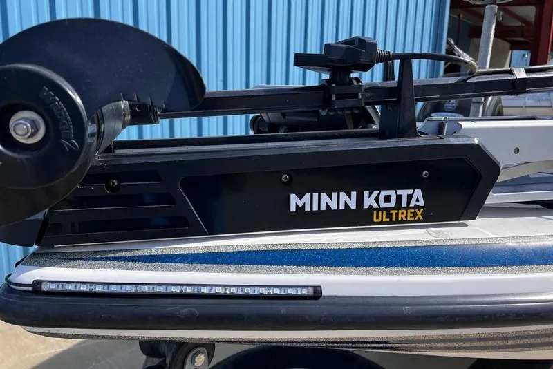 Slide: The Image of Minn Kota Ultrex trolling motor on 1999 Skeeter SX170 boat, blue background. - 13