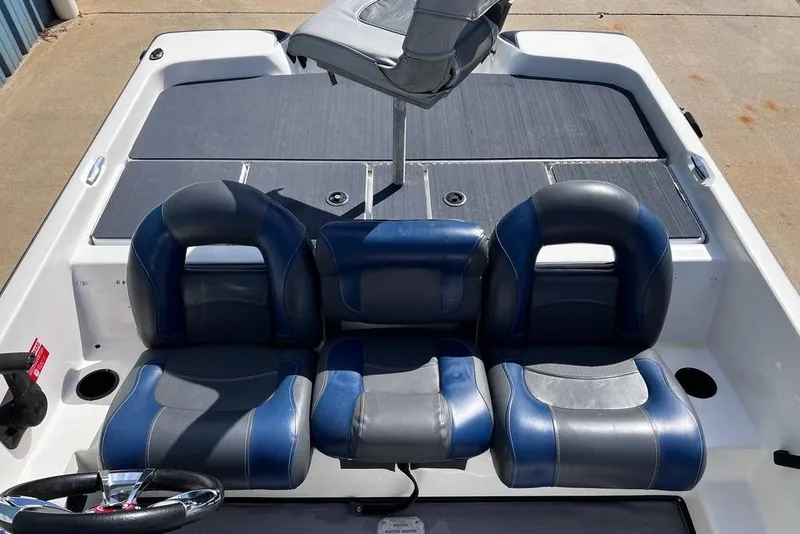 Slide: The Image of 1999 Skeeter SX170 boat interior with blue and gray seating and steering wheel. - 16