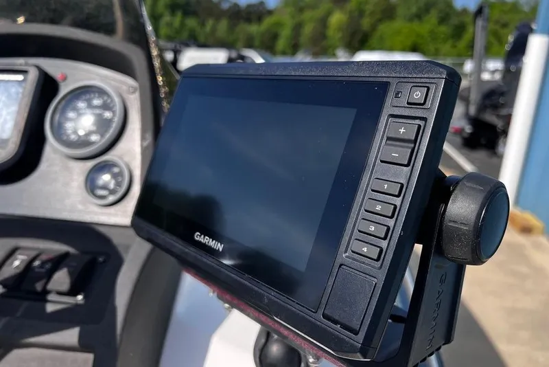 Slide: The Image of Garmin GPS device on 1999 Skeeter SX170 boat dashboard with gauges. - 17