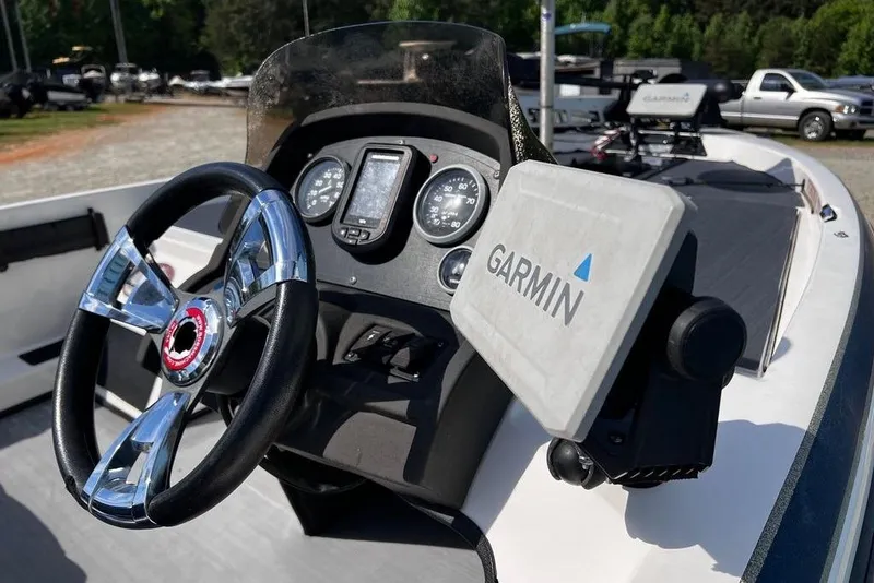 Slide: The Image of 1999 Skeeter SX170 boat dashboard with Garmin GPS and chrome steering wheel. - 18