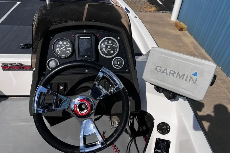 Slide: The Image of 1999 Skeeter SX170 boat dashboard with Garmin GPS and chrome steering wheel. - 19