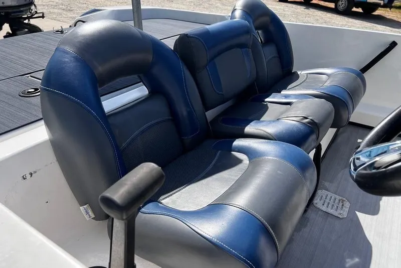 Slide: The Image of 1999 Skeeter SX170 boat interior with blue and gray seating, steering wheel visible. - 20