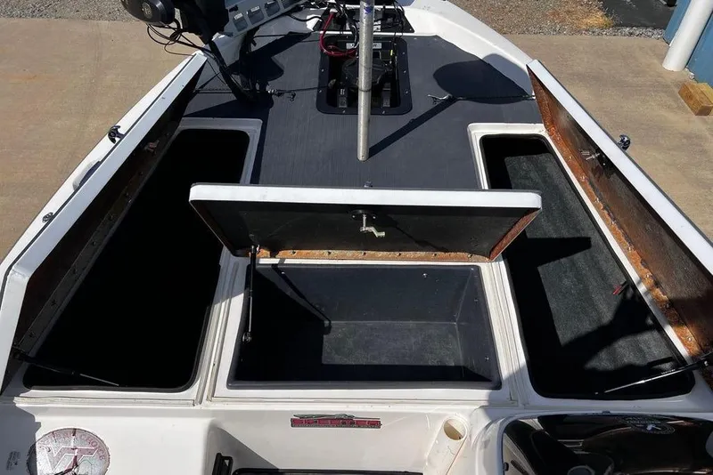Slide: The Image of 1999 Skeeter SX170 boat with open storage compartments on deck. - 21