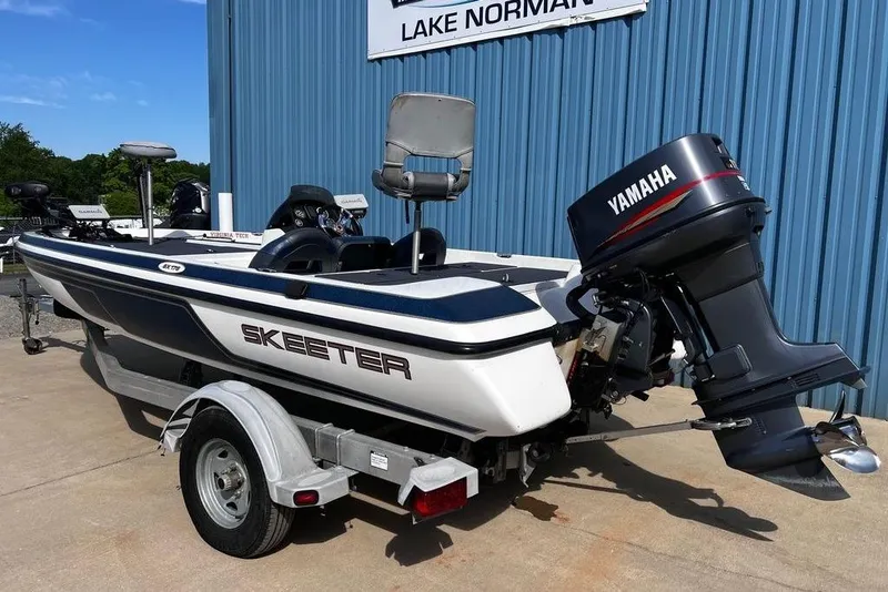 Slide: The Image of 1999 Skeeter SX170 boat with Yamaha motor, parked outside Lake Norman facility. - 3