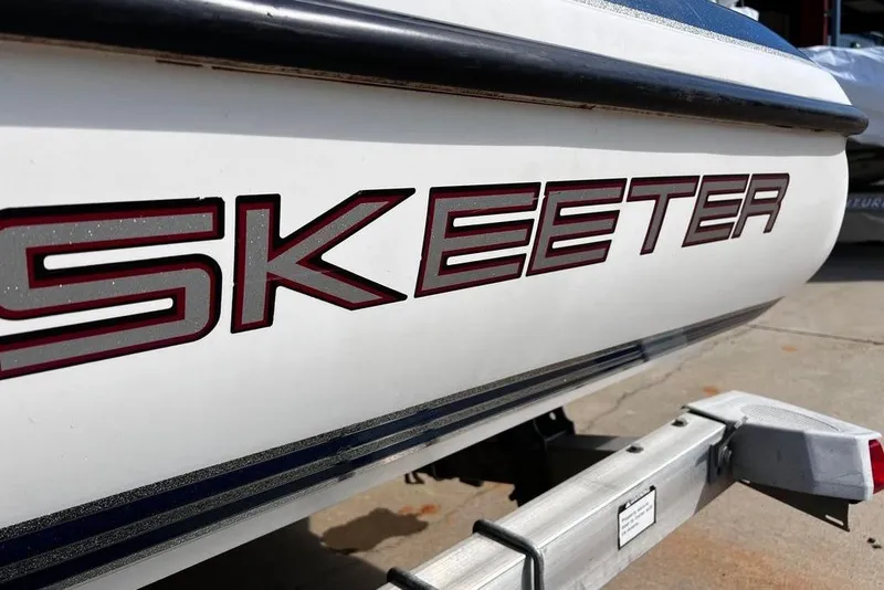 Slide: The Image of 1999 Skeeter SX170 boat with bold logo on trailer. - 7