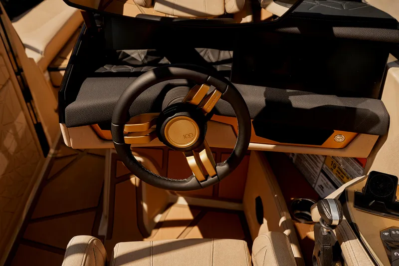 Slide: The Image of 2025 Nautique Super Air Nautique G25 Paragon steering wheel and dashboard in luxury interior. - 13