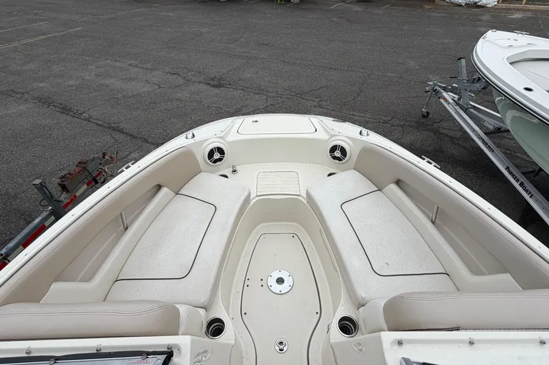Slide: The Image of 2009 Sea Ray 210 Sundeck boat interior with spacious seating and cup holders. - 13