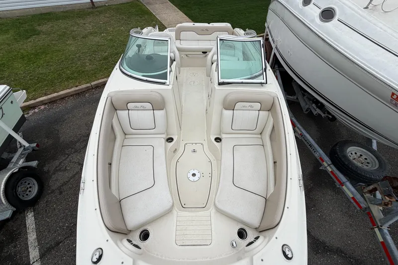 Slide: The Image of 2009 Sea Ray 210 Sundeck boat interior with spacious seating and windshield. - 16