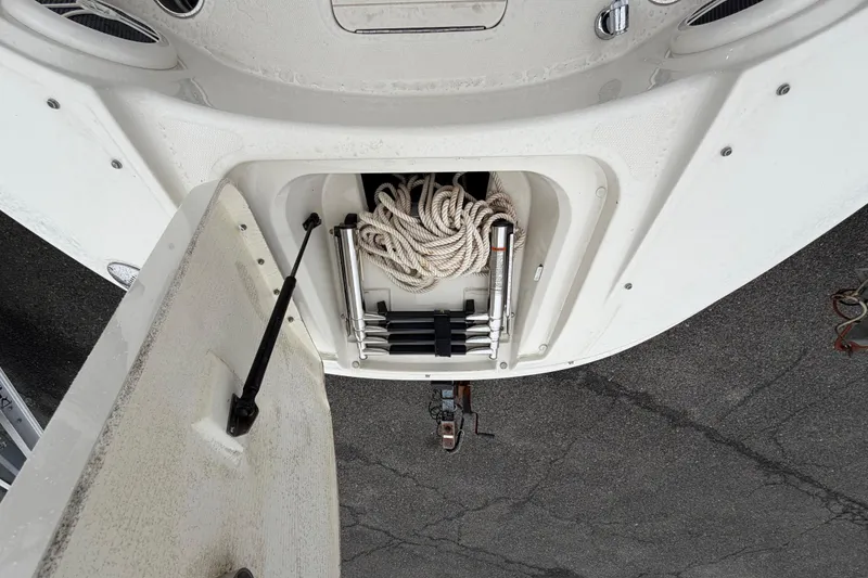 Slide: The Image of Open storage compartment on a 2009 Sea Ray 210 Sundeck with rope and ladder. - 20
