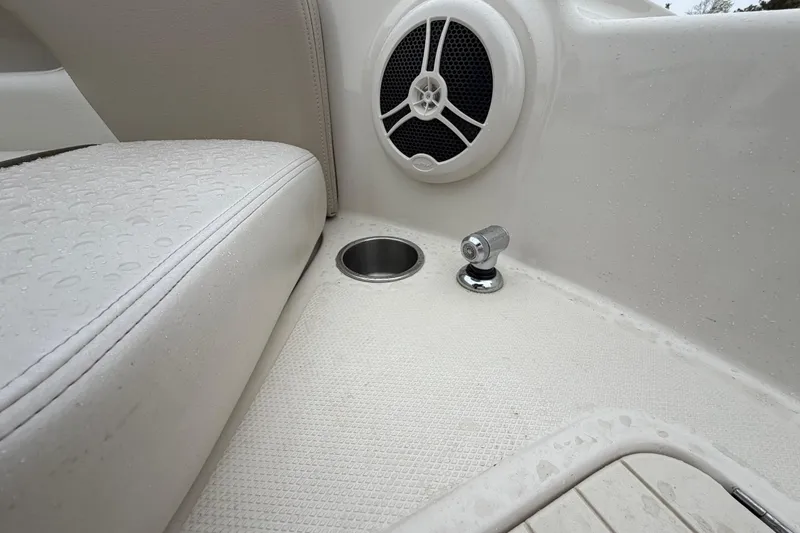 Slide: The Image of 2009 Sea Ray 210 Sundeck interior with wet seating, speaker, and cup holder. - 21