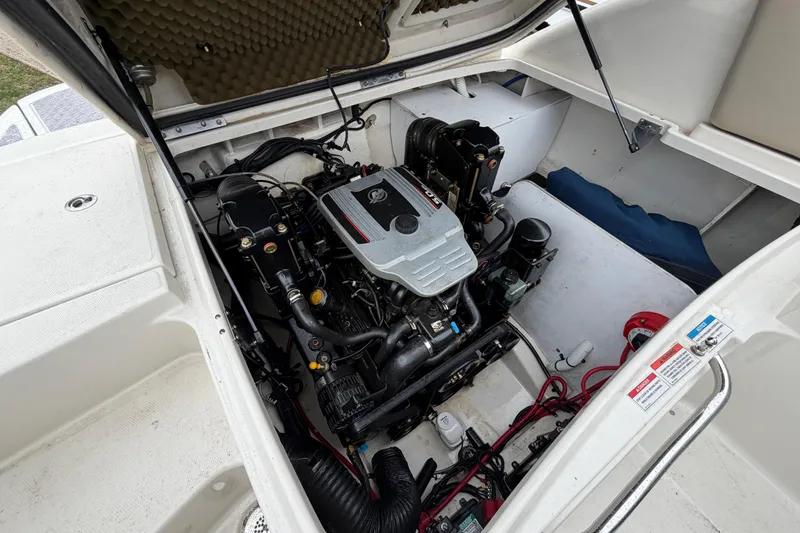 Slide: The Image of Engine compartment of a 2009 Sea Ray 210 Sundeck boat, showcasing detailed components. - 23