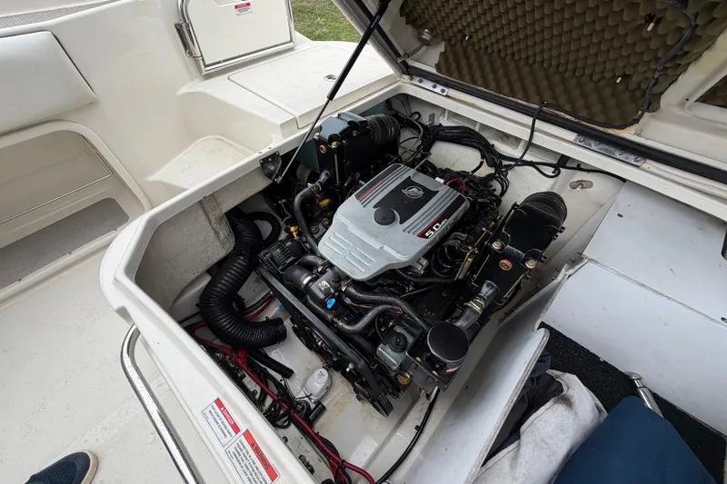 Slide: The Image of Engine compartment of a 2009 Sea Ray 210 Sundeck boat, showcasing the motor details. - 24